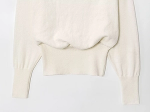 Detailed macro view of pure white knit texture on sweater hem and cuffs for women