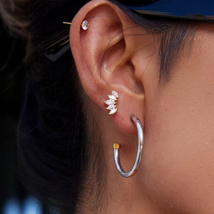 Modern minimalist 18K gold and silver mixed metal C-shape hoop earrings on model