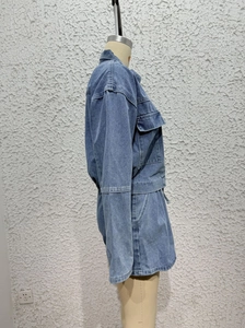 Detailed side view of light blue denim jacket set with metal buttons and stitching