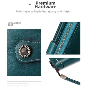 Close-up of premium gold hardware and smooth zipper on dark green RFID leather wallet