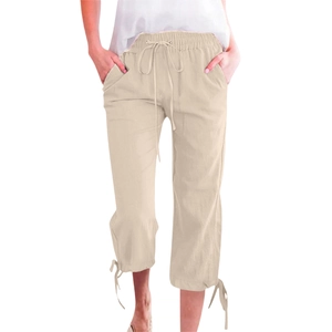 Detailed close-up of drawstring elastic waistband and side pockets on beige casual pants
