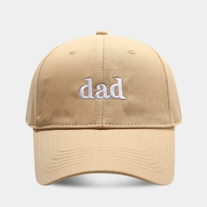 Close-up of white dad embroidery on khaki cotton twill baseball cap with curved brim