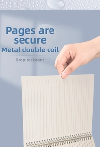 Detail of durable metal double-coil binding and lined pages for B5 spiral notebook