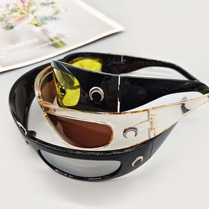 Close-up of wrap-around sports sunglasses with colorful lenses and metallic crescent logos