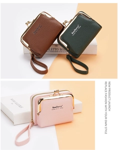 Close-up of pebble leather coin purses in brown, green, and pink with metal clasps