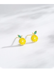 Macro shot of S925 silver lemon earrings with yellow enamel and green gemstone leaf
