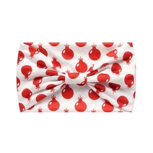 Detail of white Christmas headband with red holiday ornament prints and a central bow knot