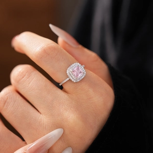 Macro shot of crown ring with square pink zircon gemstone and pavé diamonds on model finger