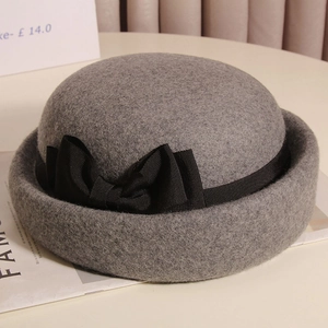 Vista dettagliata dall'alto di un cappello cloche in feltro grigio con fiocco nero