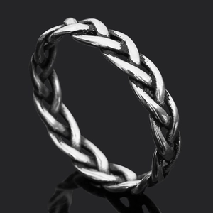 Macro view of vintage silver titanium steel ring with woven Viking rune textures