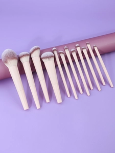 Close-up of 12-piece pink makeup brush set with gradient brown and white synthetic bristles