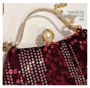 Detail of velvet dinner bag lock and handle, push back 0.5 cm to unlock the pearl clasp
