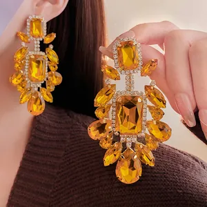 Exaggerated silver needle earrings with yellow crystals and sparkling pavé diamonds