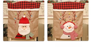 Detail of Santa and Snowman chair covers with red plaid texture and burlap fabric