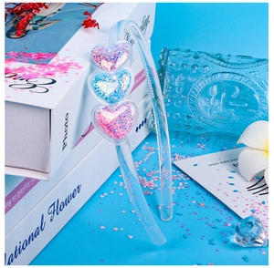 Detail of candy-colored heart headband with sparkling sequins and transparent frame