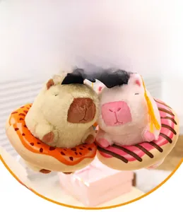 Close-up of cute plush capybaras with graduation caps sitting in donut bases