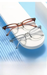 Close-up of retro half-frame glasses in tortoiseshell and transparent grey with metal rims