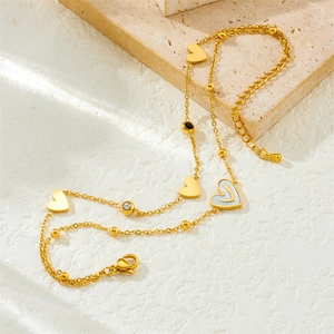 Double-layered gold-plated anklet with heart pendants and crystal accents on stone