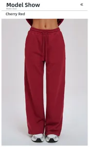 Detail view of loose wide-leg joggers in cherry red with adjustable drawstring waist