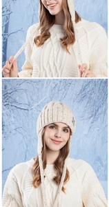 Detail of cream knit ear-flap hat with colorful flecks and chunky braided sweater