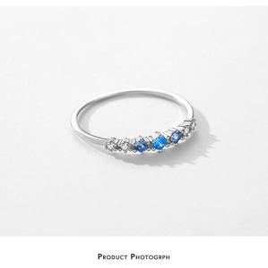 Close-up of S925 silver ring featuring gradient blue and white cubic zirconia stones