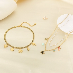 Golden double-layer anklet with ocean shell and starfish charms on silk background