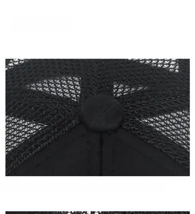 Detail view of the breathable mesh crown and top button on a black baseball sun cap