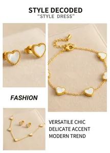 Macro detail of gold-plated heart jewelry set featuring white shell inlay and beaded edges