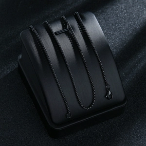 Macro shot of 2mm black stainless steel box chain necklace with a lobster clasp closure