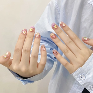Handmade press-on nails with spring daisy painting and gold foil on pink jelly base
