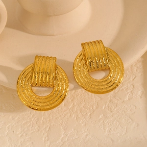 Detail of 18k gold plated stainless steel earrings with hammered texture and geometric design