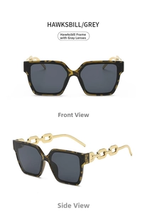 Detail of tortoise frame sunglasses with grey lenses and gold metal chain temples