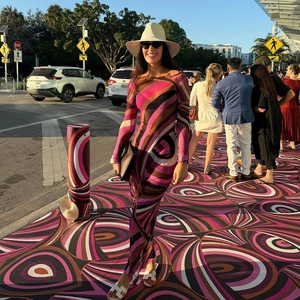 Detailed view of long sleeve maxi dress featuring psychedelic swirl print in pink and brown