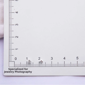 Macro shot of S925 sterling silver geometric beads on scale ruler for DIY jewelry