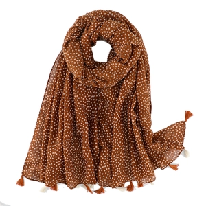 Detail of vintage floral pattern on caramel cotton linen scarf with tassel fringe edges