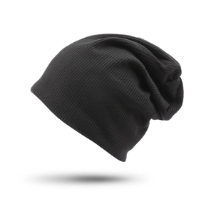 Detailed close-up of the black waffle knit texture on this warm slouchy beanie hat