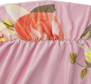 Close-up of pink maternity dress fabric with floral print and elastic smocked detail