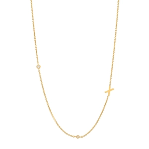 Close-up of a gold S925 sterling silver initial X necklace with shimmering zircons