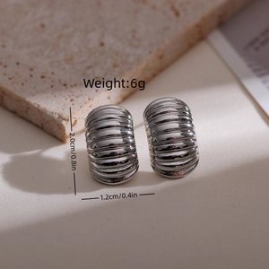 Detail view showing 18k gold plated ribbed earrings with size and weight specs
