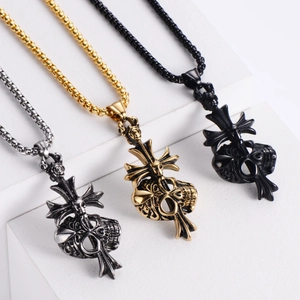 Three gothic skull cross necklaces in silver, gold and black on white geometric platforms
