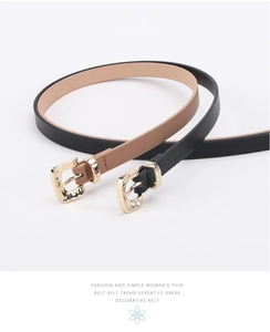 Detail of thin fashion belts in black and camel leather with elegant gold metal buckles