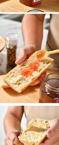 Silicone double-ended spatula spreading fruit jam on bread in a cozy wooden kitchen