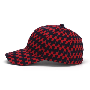 Side view detail of a classic red and black houndstooth pattern baseball cap with curved brim