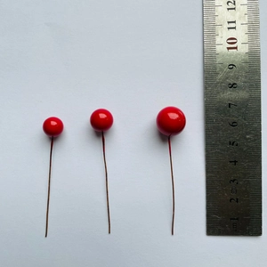Artificial red berries for Christmas DIY decor in three sizes with a ruler scale