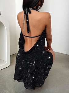 Detail of a black halter backless mini dress with sparkling sequin fabric and drape