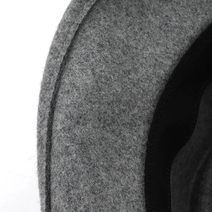 Detailed close-up of stitching and interior sweatband on a grey wool felt cloche hat