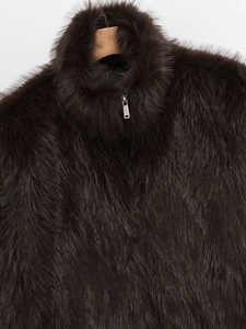 Detail of dark brown faux fur vest with a high neck metal zipper and soft plush texture