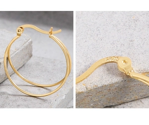 Macro detail of S925 sterling silver stamp on minimalist gold double hoop earrings