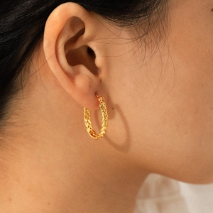 Minimalist 18k gold C-shaped twisted hoop earrings for women in stainless steel texture