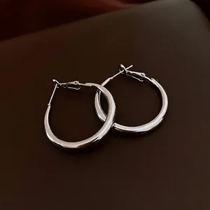Minimalist silver hoop earrings for women featuring a high-polished metallic finish